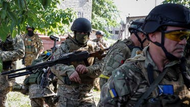Members of foreign volunteers unit which fights in the Ukrainian army walk, as Russia's attack on Ukraine continues, in Sievierodonetsk, Luhansk region Ukraine June 2, 2022. (Reuters)