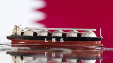 Model of LNG tanker is seen in front of Qatar's flag in this illustration taken May 19, 2022. (Reuters)