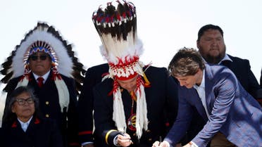 Canada's Prime Minister Justin Trudeau arrives with Siksika Nation Nioksskaistamik (Chief) Ouray Crowfoot at a news conference in Siksika Nation, Alberta, Canada June 2, 2022. REUTERS/Todd Korol