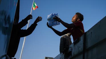Volunteers load water bottles on a truck, destined for troops battling Tigrayan rebels, in Addis Ababa, Ethiopia, on November 30, 2021. (AFP)
