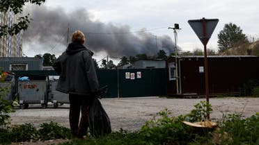 A man looks at the smoke after explosions were heard as Russia's attacks on Ukraine continues, in Kyiv, Ukraine June 5, 2022. (Reuters)