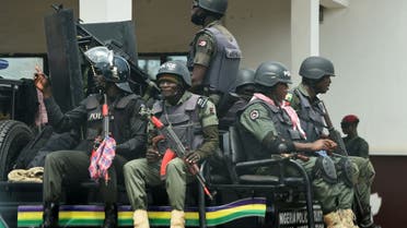 Police men sit on a truck as they patrol ahead of next November 6 governorship election in Akwa, Anambra State in southeast Nigeria, on November 3, 2021. (AFP)