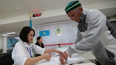 A man prepares to cast his ballot at a polling station during a constitutional referendum, in Koyandy, Akmola region, Kazakhstan, on June 5, 2022. (Reuters)