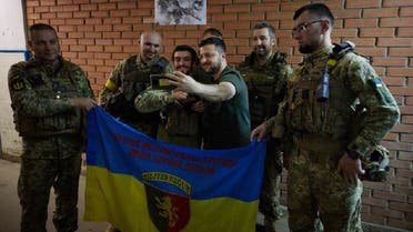 Ukrainian president Volodymyr Zelenskyy (C) taking a picture with awarded Ukrainian servicemen during his visit to the frontline positions of the army at Bakhmut and Lysychansk districts. (AFP)
