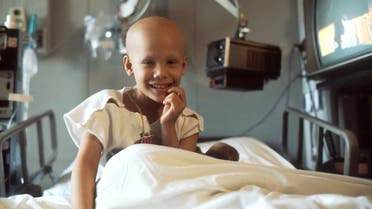Stock image of a child sitting in a hospital bed, being treated for cancer. (Unsplash, the National Cancer Institute)