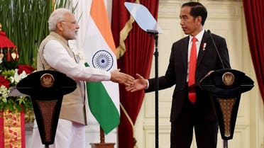 Indonesia’s President Joko Widodo (R) shakes hands with India’s Prime Minister Narendra Modi during a joint press conference at the presidential palace in Jakarta on May 30, 2018. (AFP)