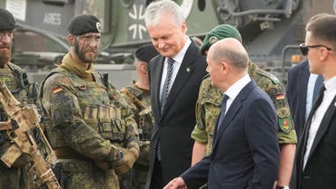 German Chancellor Olaf Scholz and Lithuanian President Gitanas Nauseda visit NATO enhanced Forward Presence battlegroup German troops in Pabrade, Lithuania on June 7, 2022. (Reuters)