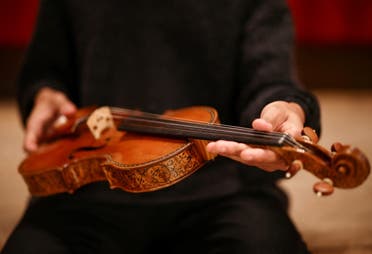 Violinist Braimah Kanneh-Mason holds the rare 'Hellier' violin, created by Italian luthier Antonio Stradivari in 1679, which will be offered in the Exceptional Sale at Christie's auction house - scheduled for July 7th, in London, Britain, May 30, 2022. (Reuters)