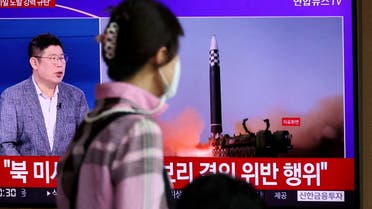 FILE PHOTO: A woman watches a TV broadcasting a news report on North Korea's launch of three missiles including one thought to be an intercontinental ballistic missile (ICBM), in Seoul, South Korea, May 25, 2022. REUTERS/Kim Hong-Ji/File Photo