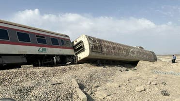 A handout picture made available by the Iranian Red Crescent on June 8, 2022 shows rescuers at the scene of a train derailment near the central Iranian city of Tabas on the line between the Iranian cities of Mashhad and Yazd. (AFP) 