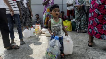 A child waiting to buy kerosene with his mother in the morning plays with cans, during a shortage of domestic gas as a result of country's economic crisis, at a fuel station in Colombo, Sri Lanka March 18, 2022. (File photo: Reuters)