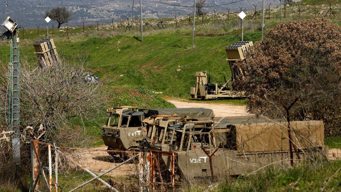 A picture shows Iron Dome defence system batteries, designed to intercept and destroy incoming short-range rockets and artillery shells, and Israeli military vehicles stationed near the border with Lebanon in the Israeli annexed Golan Heights on February 18, 2022. (AFP)