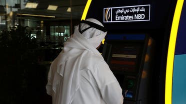 A customer uses an ATM machine at the Emirates NBD head office in Dubai, UAE. (Reuters)