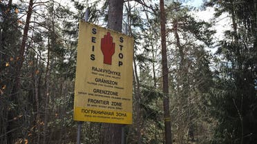 A sign reads ‘Stop, border area,’ in a forest in the countryside of Imatra, south-eastern Finland, on May 13, 2022. (AFP)
