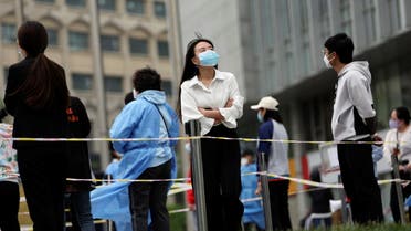 People line up at a makeshift nucleic acid testing site during a mass testing for the coronavirus disease (COVID-19) in Chaoyang district of Beijing, China May 10, 2022. REUTERS/TIngshu Wang