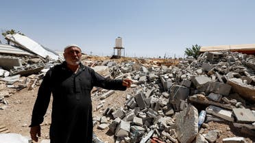 Palestinian Mahmoud Najajreh points at his demolished house, in Masafer Yatta, South of Hebron, in the Israeli-occupied West Bank, May 31, 2022. Picture taken May 31,2022. (Reuters)
