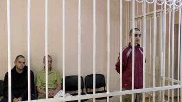 A still image, taken from footage of the Supreme Court of the self-proclaimed Donetsk People's Republic, shows Britons Aiden Aslin, Shaun Pinner and Moroccan Brahim Saadoun captured by Russian forces during a military conflict in Ukraine, in a courtroom cage at a location given as Donetsk, Ukraine, in a still image from a video released June 8, 2022. (Reuters)