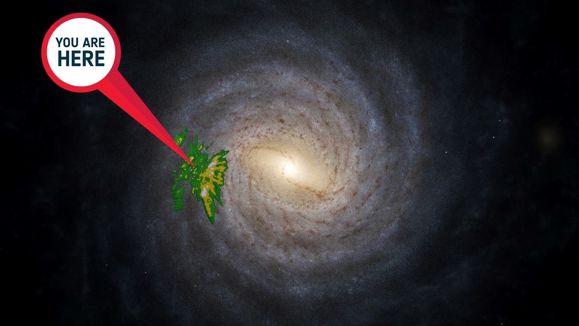 This handout image released by the European Space Agency (ESA) on June 13, 2022, an artistic impression of the Milky Way, and on top of that an overlay showing the location and densities of a young star sample from Gaia’s data release 3 (in yellow-green). The “you are here” sign points towards the Sun.