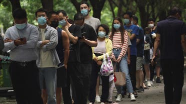 People line up for nucleic acid tests at a mobile testing booth, following the coronavirus disease (COVID-19) outbreak, in Beijing, China, on June 13, 2022. (Reuters)