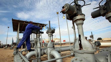 A worker checks pipes and valves at Amaal oil field in eastern Libya. (Reuters)