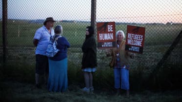 Protesters in support of asylum seekers wait at the perimeter of the airport, in Wiltshire, Britain, June 14, 2022. (Reuters)