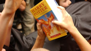 A child holds a copy of Harry Potter and the Order of the Phoenix, at Waterstone's bookshop in central London 21 June, 2003. (File photo: Reuters)
