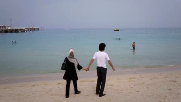 File photo of a couple holding hands while walking on the beach of Kish Island, 1,250 kilometers (777 miles) south of Tehran April 26, 2011. (Reuters)