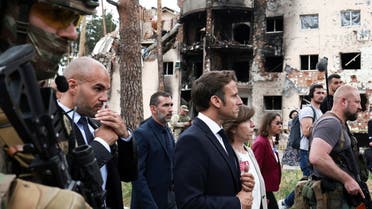 French President Emmanuel Macron walks with French Foreign Affairs Minister Catherine Colonna during a visit alongside Italian Prime Minister Mario Draghi, German Chancellor Olaf Scholz, and Romanian President Klaus Iohannis to Irpin, as Russia's attack on Ukraine continues, near Kyiv, Ukraine June 16, 2022. (Reuters)