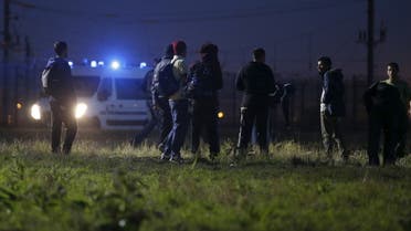 Migrants walk close to a Eurotunnel fence, as police arrive in a van, during an attempt to access the Channel Tunnel in Frethun, near Calais, France, August 2, 2015. (File photo: Reuters)
