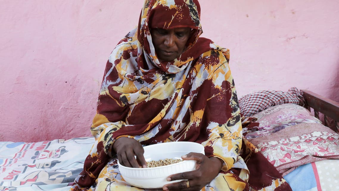 Magda Ahmed, Sudanese mother of orphan children who applied for Sudan’s Thamarat Family Support Programme, holds a bowl of food in South Khartoum April 26, 2021. Picture taken April 26, 2021. REUTERS/El-Tayeb Siddig