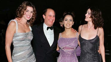 Revlon cosmetics chairman Ronald O. Perelman poses with models (L-R) Cindy Crawford and Salma Hayek and actress Kim Delaney at the ninth annual Fire & Ice Ball December 9, 1998, at Universal Studios in Los Angeles. (Reuters)