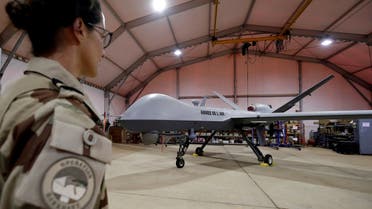A French soldier of the regional anti-insurgent Operation Barkhane stands in front of a General Atomics MQ-9 Reaper drone version Block 1 in Niamey, Niger, October 21, 2017. (Reuters)