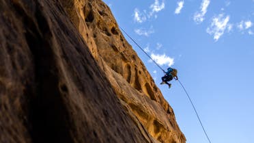 View shows a person rappelling down a mountainside. (Supplied)