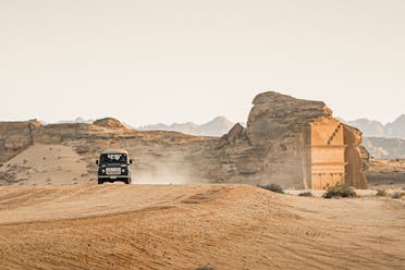 View shows a vintage Land Rover against the backdrop of a heritage site in AlUla, Saudi Arabia. (Supplied)