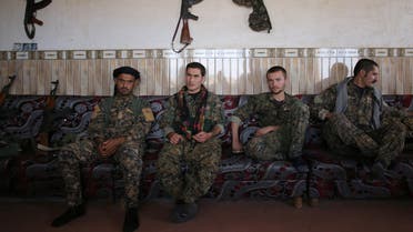 Members of the Sinjar Resistance Units (YBS), a militia affiliated with the Kurdistan Workers' Party (PKK), sit with an Arab tribal fighter (L) in a house in the village of Umm al-Dhiban, northern Iraq, April 30, 2016. (Reuters)