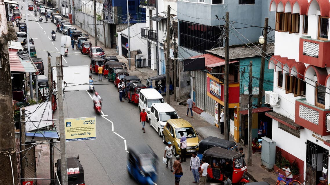 Vehicle owners wait in a queue to buy petrol due to fuel shortage, amid the country's economic crisis, in Colombo, Sri Lanka June 17, 2022. (Reuters)