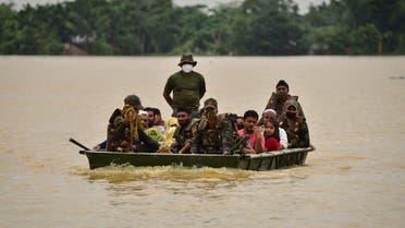 Indian Army soldiers evacuate people from flooded area to a safer place after heavy rains at a village in Hojai district, in the northeastern state of Assam, India, on June 18, 2022. (Reuters)