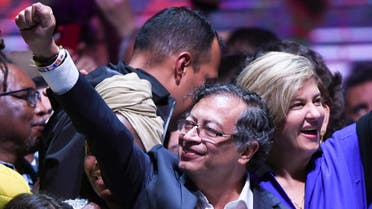 Newly elected Colombian President Gustavo Petro (C) celebrates with his wife Veronica Alcocer (R) at the Movistar Arena in Bogota, on June 19, 2022 after winning the presidential runoff election on June 19, 2022. Ex-guerrilla Gustavo Petro was on Sunday elected the first ever left-wing president of crisis-wracked Colombia after beating millionaire businessman rival Rodolfo Hernandez after a tense and unpredictable election. (Photo by Juan BARRETO / AFP)