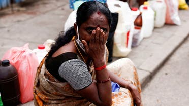 A woman waits in a queue to buy kerosene while sitting on a pavement, amid the country's economic crisis, in Colombo, Sri Lanka June 17, 2022. (File photo: Reuters)