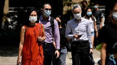 People wearing face masks cross a road, amid the coronavirus Omicron wave in Singapore. (File photo: Reuters)