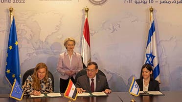 European Commission President Ursula von der Leyen (back) looks on as EU Commissioner for Energy Kadri Simson (L), Egyptian Minister of Petroleum Tarek el-Molla(C), and Israeli Minister of Energy Karine Elharrar (R) sign a trilateral natural gas deal at the ministerial meeting of the East Mediterranean Gas Forum (EMGF) in Cairo on June 15, 2022. (AFP)