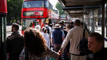 Passengers queue for a bus outside the Waterloo Station, on the first day of national rail strike in London, Britain, on June 21, 2022. (Reuters)