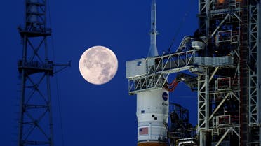 A full moon, known as the Strawberry Moon is shown with NASA’s next-generation moon rocket, the Space Launch System (SLS) Artemis 1, at the Kennedy Space Center in Cape Canaveral, Florida, U.S. June 15, 2022. REUTERS/Joe Skipper