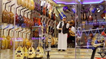 A Saudi violinist plays the violin at a musical instruments shop at the Hilla market, in Riyadh, Saudi Arabia, on January 20, 2020. (Reuters)