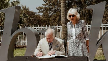 Britain’s Prince Charles, accompanied by his wife Camilla, signed a note of remembrance at the Kigali Genocide Memorial. (AFP)