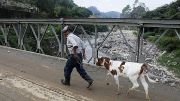 A man walks on a bridge over the Las Vacas river considered one of the most polluted rivers in the world, in the municipality of Chinautla. (File photo: Reuters)
