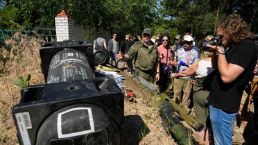 A group of foreign journalists listen to a Russian officer, center, as they check a captured Ukrainian checkpoint, well-fortified trenches and a Javelin, an American-made portable anti-tank missile system, left, near Schastia town, on the territory which is under the Government of the Luhansk People's Republic control, eastern Ukraine, Saturday, June 11, 2022. This photo was taken during a trip organized by the Russian Ministry of Defense