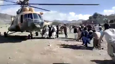 People carry injured to a helicopter following a massive earthquake, in Paktika Province, Afghanistan, June 22, 2022. (Reuters)