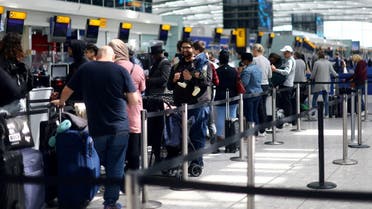 Passengers queue for check-in desks at Heathrow airport's Terminal 5 in London, Britain, on June 1, 2022. (Reuters)
