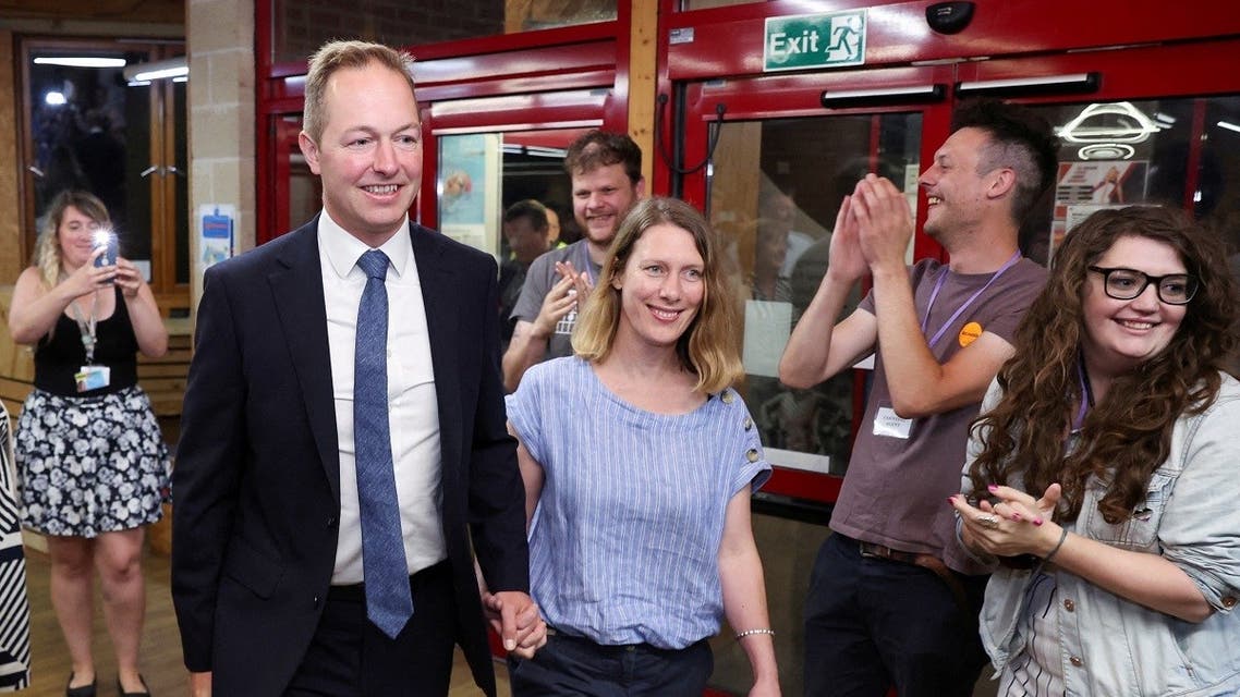 Liberal Democrats party candidate Richard Foord arrives with his wife after winning the count for the Tiverton and Honiton by-election, at Lords Meadow Leisure Center in Devon, Britain, on June 24, 2022. (Reuters)